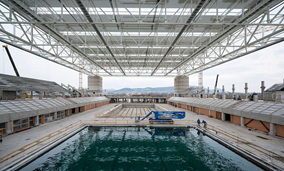 The roof is up and the first pool is being tested in Budapest at the Dagály Aquatic Center.